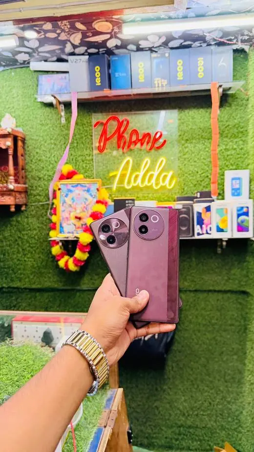 Phone Adda store with neon sign